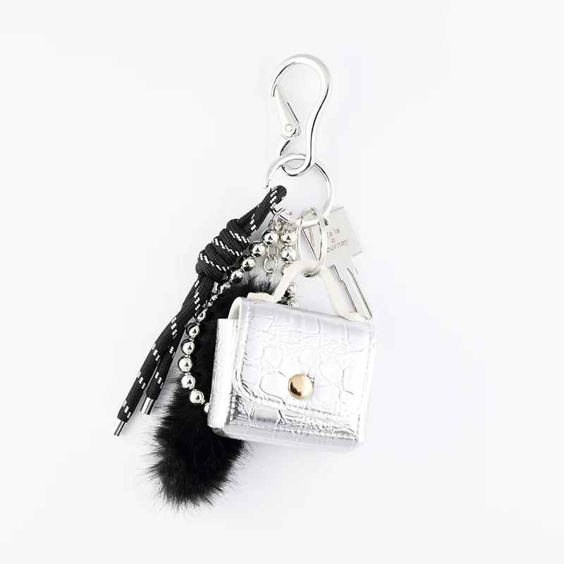 Bijoux de sac mini sac argenté et pompon noir